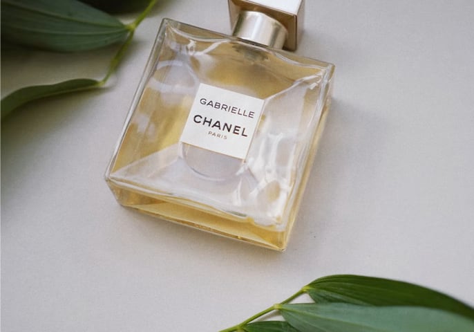 Square glass bottle of light amber-colored Chanel perfume